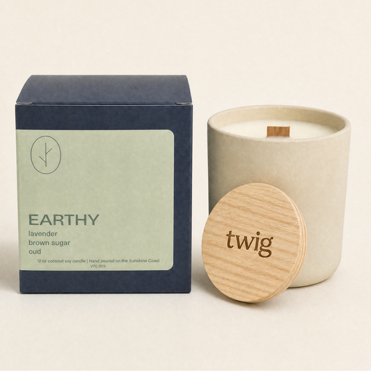 Candle with wooden lid and packaging labeled 'twig' on a beige background