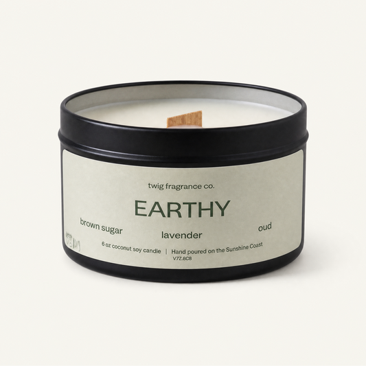 Candle with 'Earthly' label on a white background